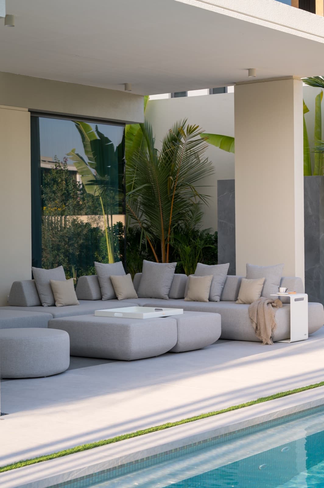 BLOOM LOFT lounge set beside the pool of a Tilal Al Ghaf villa, Dubai